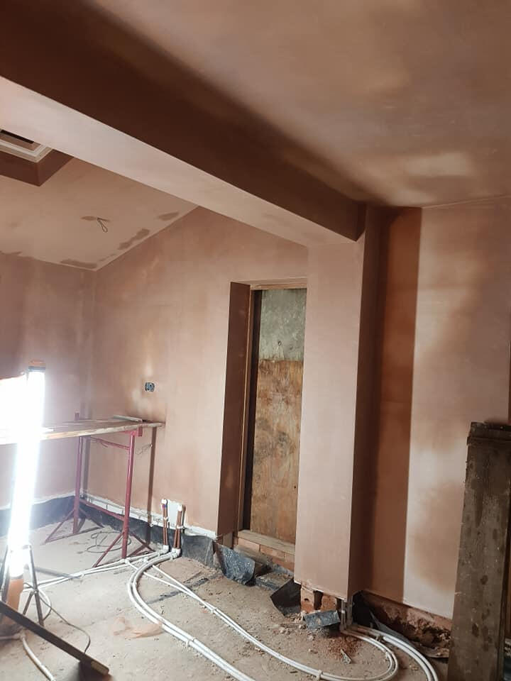 Fresh plaster on walls, ceiling and beam in a renovation